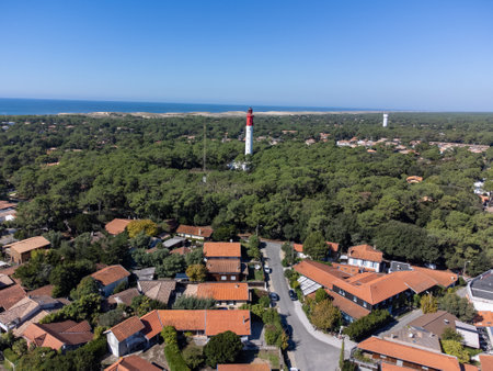 Aerial view on Arcachon Bay with many fisherman's boats and oysters farms, forest and red lighthouse Le Phare du Cap Ferret, Cap Ferret peninsula, France, southwest of Bordeaux, France's Atlantic coastlineの写真素材