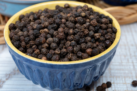 Indian spices collection, aromatic dried black peppercorns, kitchen spices