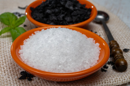 Black and white Mediterranean sea salt close up, Cyprus Black Salt shiny black pyramid-shaped...