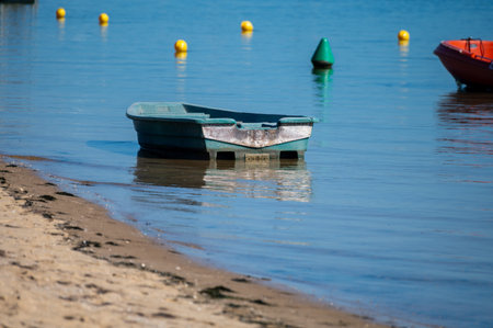 View on Arcachon Bay with many fisherman's boats and oysters farms near Le Phare du Cap Ferret, Cap Ferret peninsula, France, southwest of Bordeaux, France's Atlantic coastline in sunny dayの写真素材