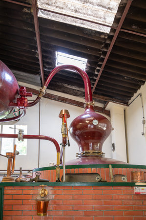 Double distillation process of cognac spirit in Charentias copper still pots and boilers in old distillery in Cognac white wine region, Charente, Segonzac, Grand Champagne, Franceの写真素材