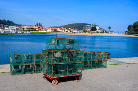 Fishing net with bucket for crayfish and crabs, Green coast of Asturias, Ribadesella village with sandy beaches, North of Spain.の写真素材