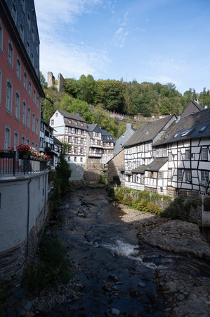 View of houses and streets of old colorful German town Monschau in bend of the river and hidden between the hills, Eifel national park, Germany in summerの写真素材