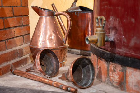 Double distillation process of cognac spirit in Charentias copper still pots and boilers in old distillery in Cognac white wine region, Charente, Segonzac, Grand Champagne, Franceの写真素材