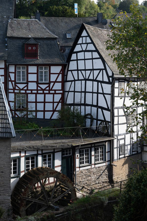 View of houses and streets of old colorful German town Monschau in bend of the river and hidden between the hills, Eifel national park, Germany in summerの写真素材