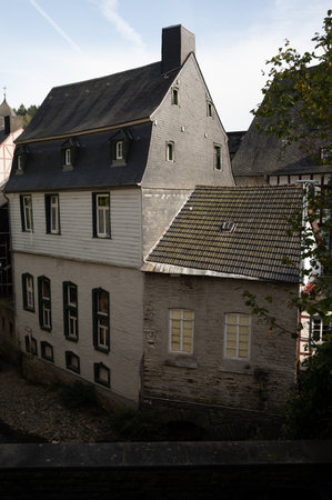 View of houses and streets of old colorful German town Monschau in bend of the river and hidden between the hills, Eifel national park, Germany in summerの写真素材