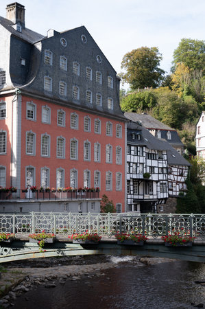 View of houses and streets of old colorful German town Monschau in bend of the river and hidden between the hills, Eifel national park, Germany in summerの写真素材