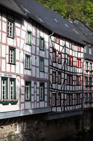 View of houses and streets of old colorful German town Monschau in bend of the river and hidden between the hills, Eifel national park, Germany in summerの写真素材