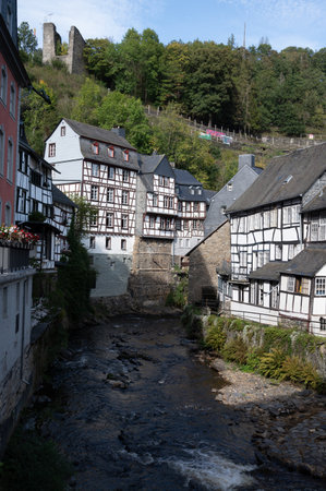 View of houses and streets of old colorful German town Monschau in bend of the river and hidden between the hills, Eifel national park, Germany in summerの写真素材