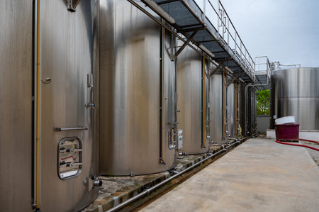 Works at distillery. Harvest time in Cognac white wine region, Charente, steel tanks for fermentation of ugni blanc grape uses for Cognac strong spirits distillation, Grand Champagne, Franceの写真素材