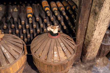 Aging process of cognac spirit in old dark French oak barrels in cellar in distillery house, Cognac white wine region, Charente, Segonzac, Grand Champagne, Franceの写真素材
