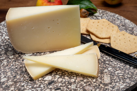 Piece of tasty Ossau-Iraty or Esquirrou sheep cheese produced in south-western France, Northern Basque Country, close upの写真素材