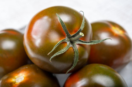 Fresh ripe sweet reddish brown and green kumato tomatoes close upの写真素材