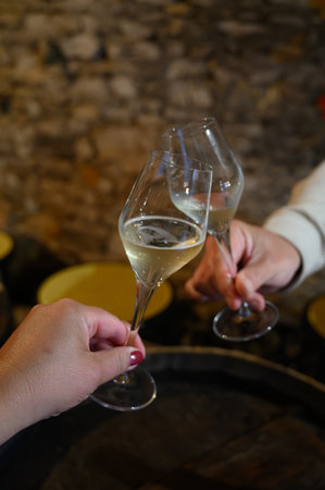 Tasting of grand cru sparkling brut white wine with bubbles champagne by old champagne caves in grand cru wine producer small village Cramant, Champagne, Franceの写真素材
