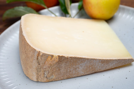 Piece of tasty Ossau-Iraty or Esquirrou sheep cheese produced in south-western France, Northern Basque Country, close upの写真素材