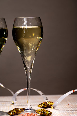 Glasses of bubble wine champagne, cremant, cava or prosecco and christmas stars for decoration close upの写真素材