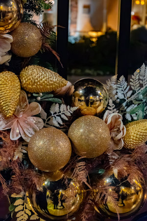Christmas and New Year street decoration, round Christmas wreath hanging on metal gate, illuminated glass door at night, Epernay in Champagne, Franceの写真素材