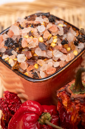 Pink himalayan salt crystals with dried seeds of red hot chili peppers and herbs, cooking with exotic salt, close upの写真素材