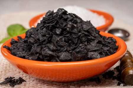 Black and white Mediterranean sea salt close up, Cyprus Black Salt shiny black pyramid-shaped crystals close upの写真素材