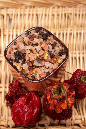 Pink himalayan salt crystals with dried seeds of red hot chili peppers and herbs, cooking with exotic salt, close upの写真素材