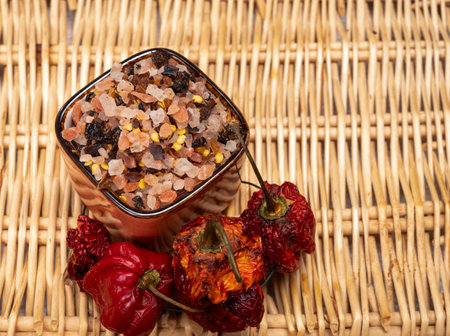 Pink himalayan salt crystals with dried seeds of red hot chili peppers and herbs, cooking with exotic salt, close upの写真素材