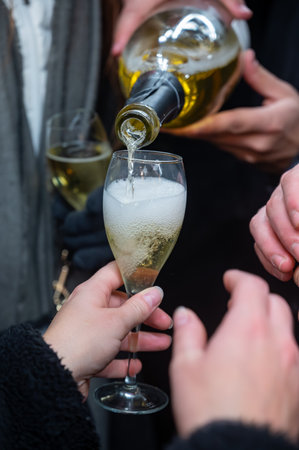 Visitors drinking of sparkling wine champagne on outdoor winter festival in December on Avenue de Champagne, Epernay, Champagne region, Franceの写真素材