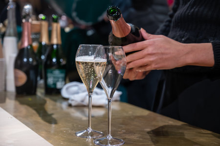 Pouring and tasting of dry sparkling wine champagne on winter weekend festival in December on Avenue de Champagne, Epernay, Champagne region, Franceの写真素材