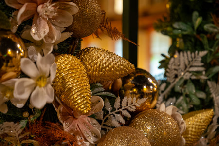 Christmas and New Year street decoration, round Christmas wreath hanging on metal gate, illuminated glass door at night, Epernay in Champagne, Franceの写真素材