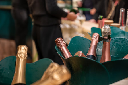 Bottles of cold sparkling wine champagne on winter weekend festival in December on Avenue de...