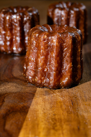 Canele, French pastry flavored with rum and vanilla, soft and tender custard center and dark, caramelized crust specialty of Bordeaux region, France close upの写真素材