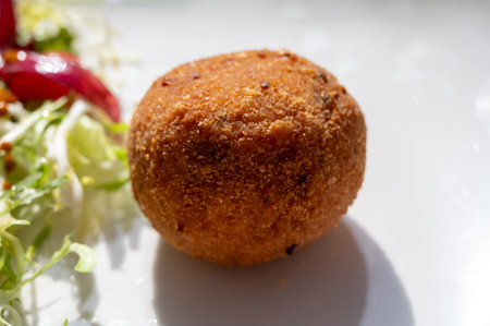 Tasty Italian street food, deep fried aranchini rice balls with different filling close upの写真素材