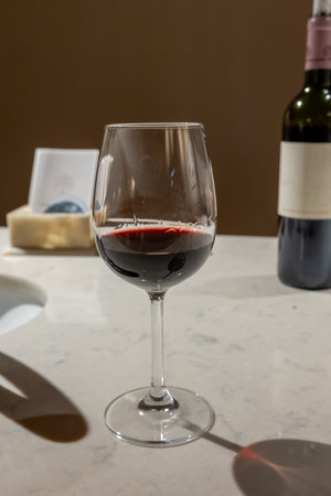Tasting of red dry Saint-Emilion wine aged in French oak wooden barrels in cellar, Saint-Emilion wine making region, France, Bordeaux made from Merlot, Cabernet Sauvignon red wine grapesの写真素材