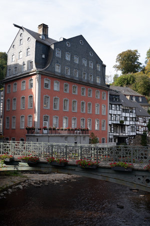 View of houses and streets of old colorful German town Monschau in bend of the river and hidden between the hills, Eifel national park, Germany in summerの写真素材
