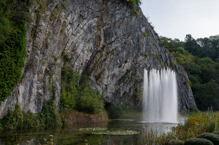 Big fountain by rock, walking in smallest medieval town in world Durbuy on river Ourthe, Ardennes, Belgium in sunny dayの写真素材
