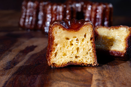 Canele, French pastry flavored with rum and vanilla, soft and tender custard center and dark, caramelized crust specialty of Bordeaux region, France close upの写真素材