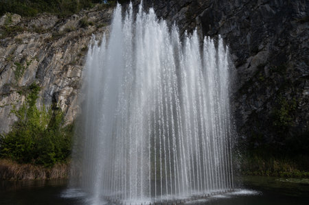 Big fountain by rock, walking in smallest medieval town in world Durbuy on river Ourthe, Ardennes, Belgium in sunny dayの写真素材