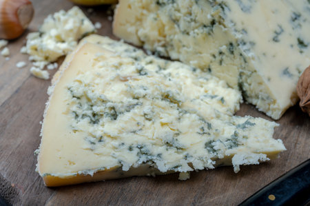 Cheese collection, English cow milk semi-soft, crumbly old stilton blue cheese close up