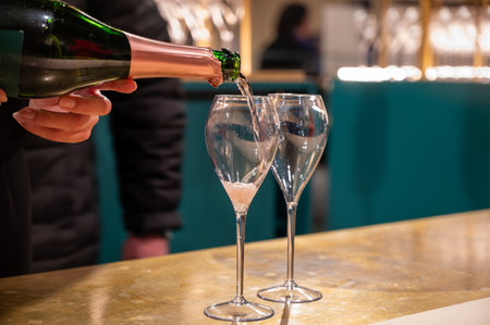 Pouring and tasting of rose sparkling wine champagne on winter weekend festival in December on Avenue de Champagne, Epernay, Champagne region, Franceの写真素材