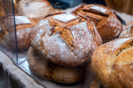 Sour dough bio bread made with natural yeast starter and baked in wood stove on food market in Franceの写真素材