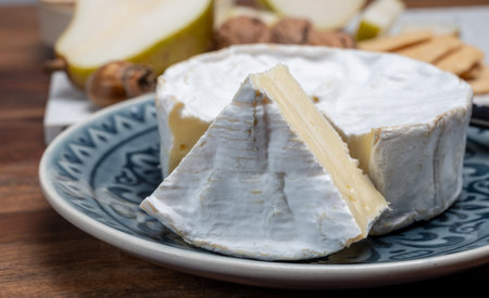 French soft Camembert cheese, original Camembert de Normandie, close up with white moldの写真素材