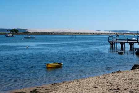 View on Arcachon Bay with many fisherman's boats and oysters farms near Le Phare du Cap Ferret and Duna du Pilat, Cap Ferret peninsula, France, southwest of Bordeaux, France's Atlantic coastline in sunny dayの写真素材