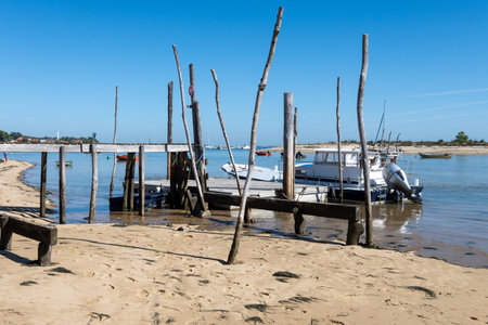 View on Arcachon Bay with many fisherman's boats and oysters farms near Le Phare du Cap Ferret, Cap Ferret peninsula, France, southwest of Bordeaux, France's Atlantic coastline in sunny dayの写真素材