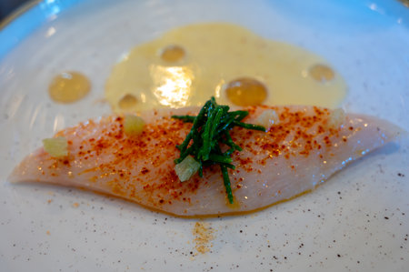 White fillet of most delicious fish John Dory, St Pierre or Peter's fish served with shell fish sauce in luxury restaurant in Bordeaux region, France, close upの写真素材