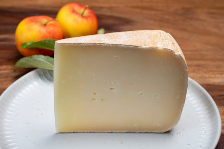 Piece of tasty Ossau-Iraty or Esquirrou sheep cheese produced in south-western France, Northern Basque Country, close upの写真素材