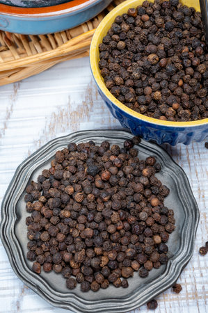 Indian spices collection, aromatic dried black peppercorns, kitchen spices