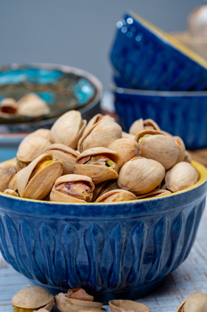 Roasted salty pistachio nuts, tasty healthy vegetarian snack food close upの写真素材