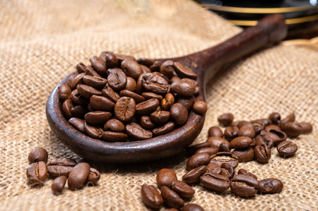 Arabica brown roasted coffee beans from Africa coffee producing region, cultivating in Ethiopia, Ivory Coast, Uganda, Kenya, Rwanda and Tanzania, close upの写真素材
