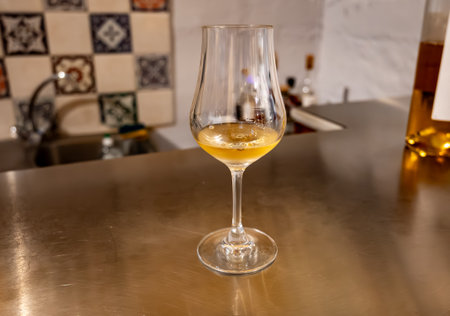 Tasting of cognac spirit aged in old dark French oak barrels in cellar in distillery house, Cognac white wine region, Charente, Segonzac, Grand Champagne, Franceの写真素材