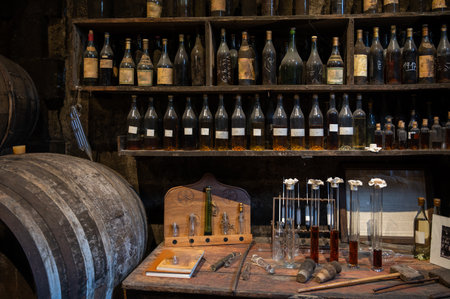 Blending process of cognac spirit and old dark French oak barrels in cellar in old family distillery house, Cognac white wine region, Charente, Segonzac, Grand Champagne, Franceの写真素材