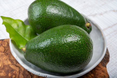 Green ripe avocado fruits from organic avocado plantation - healthy vegan and vegetarian foodの写真素材